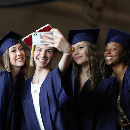 A group of graduates taking a selfie